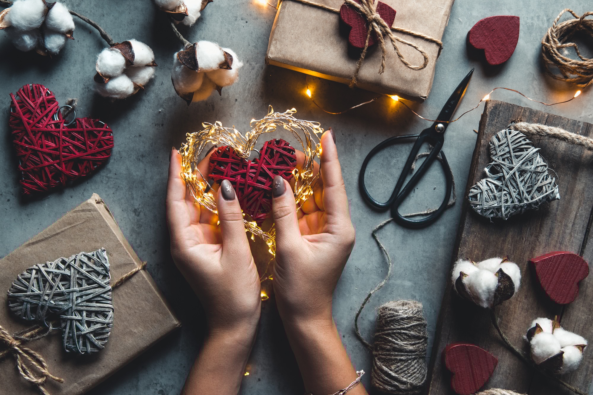 Woman preparing gift for wrapping for Valentine's Day